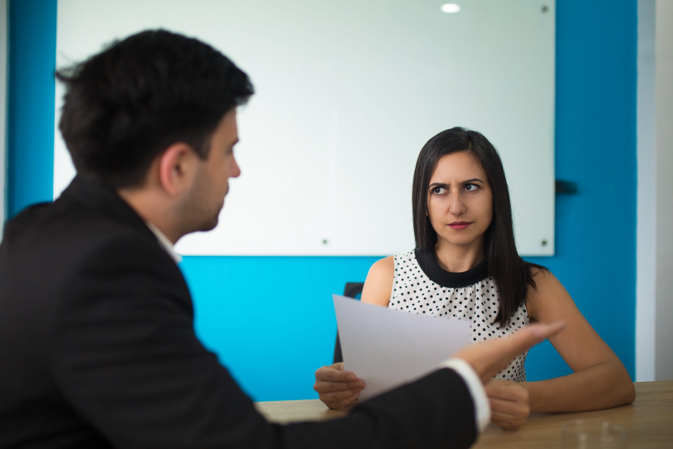 young-businesswoman-looking-male-partner-with-distrust (1)